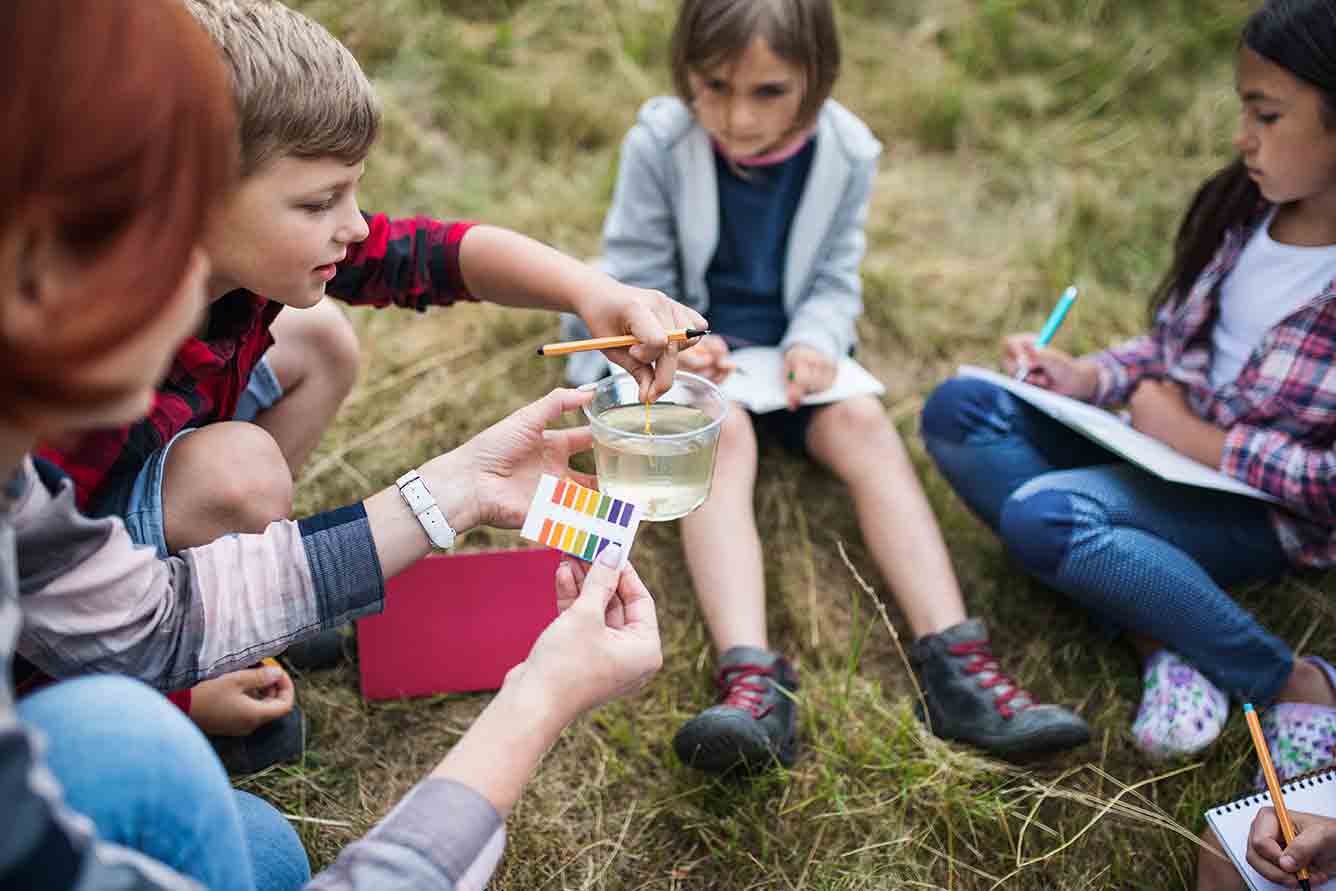 Young students participate in an outdoor science project