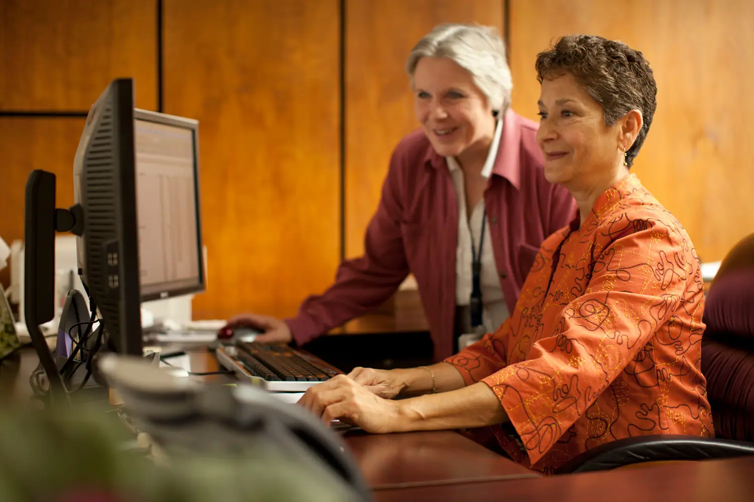 Two women working together at a computer