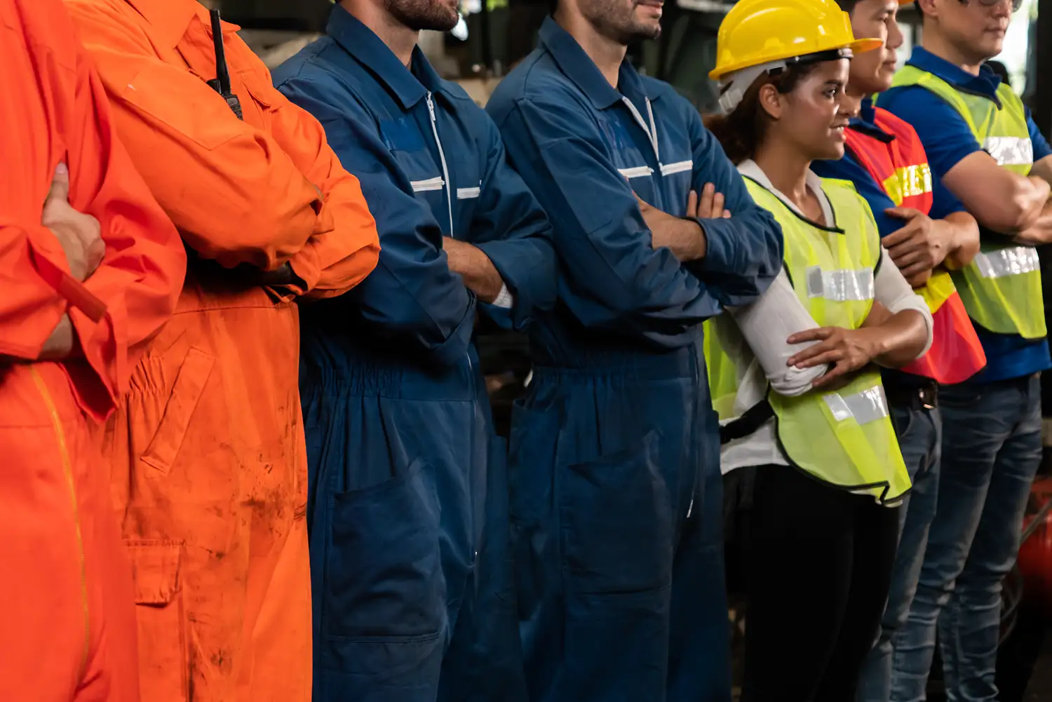 Male and female workers dressed in safety vests