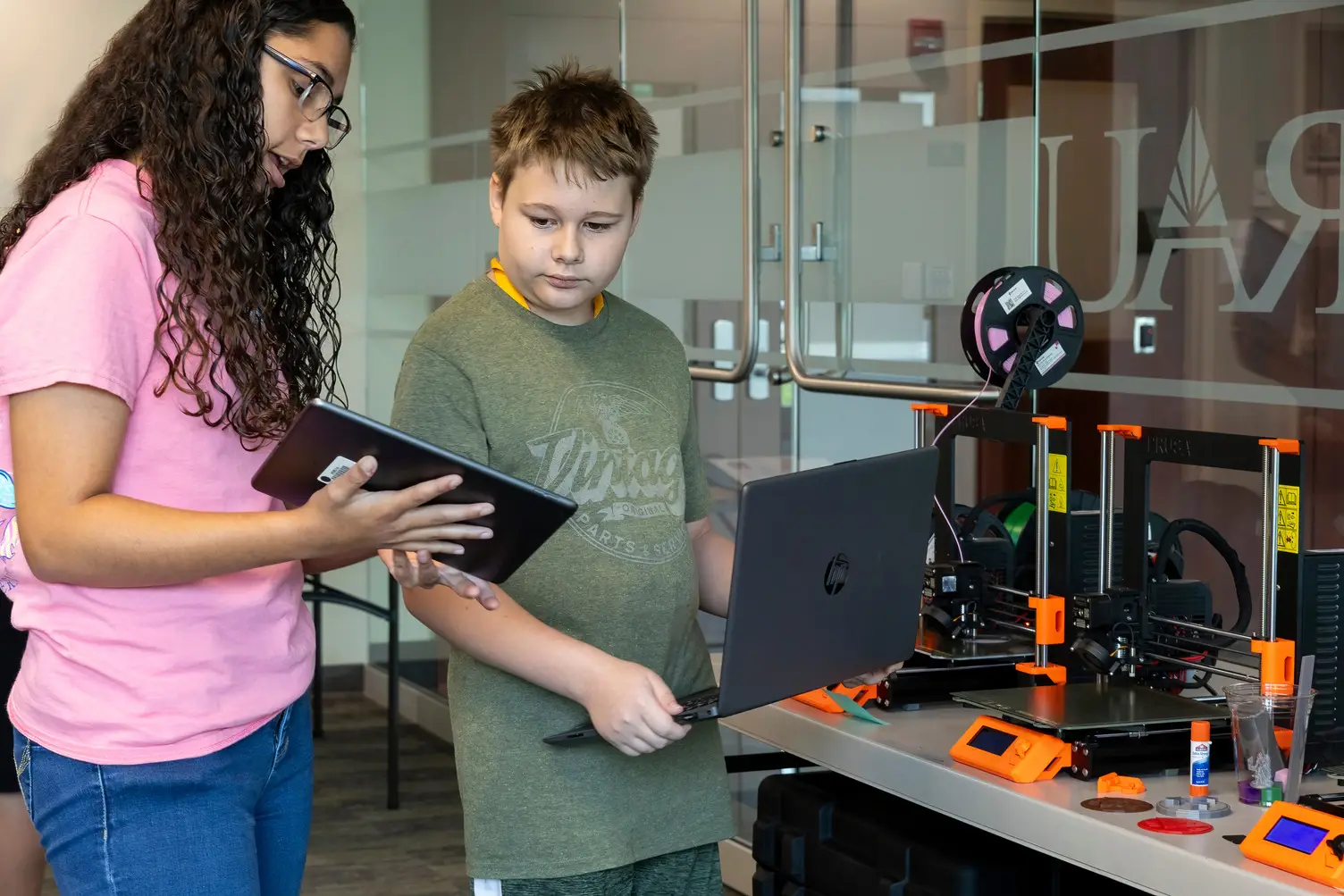 Two students work on a 3D printing project during the middle school Appalachian STEM Academy