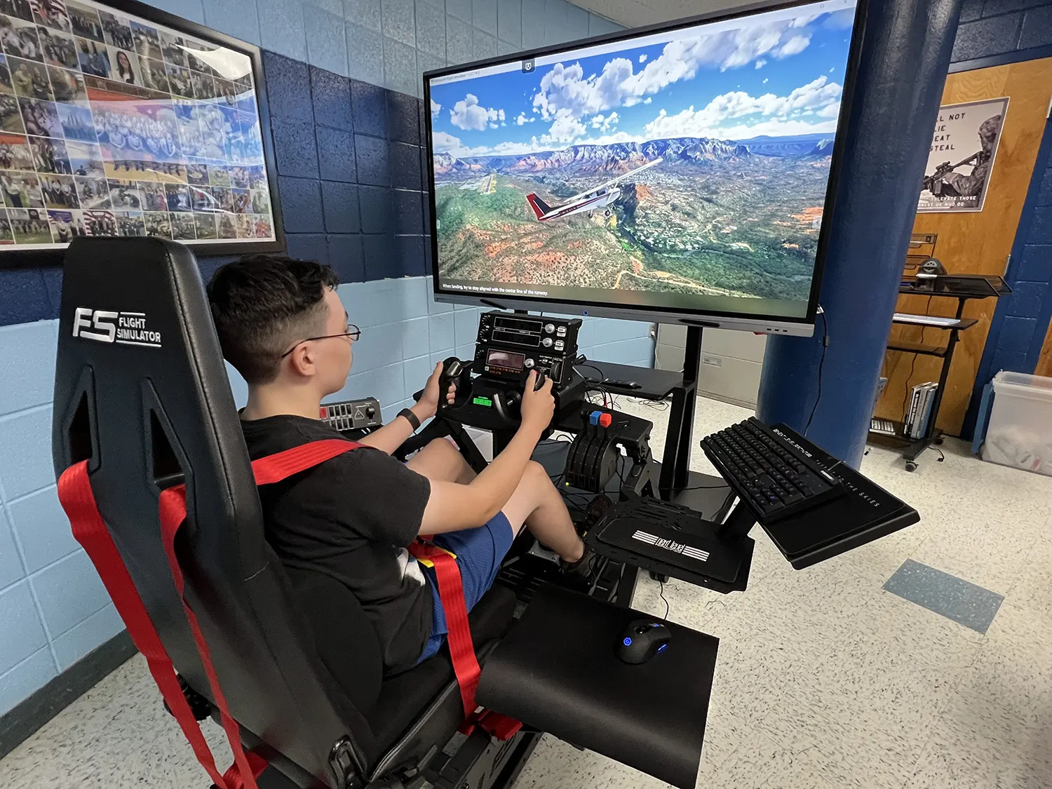 A student at Clinton High School learns to fly on the new flight simulator awarded to the ROTC class.