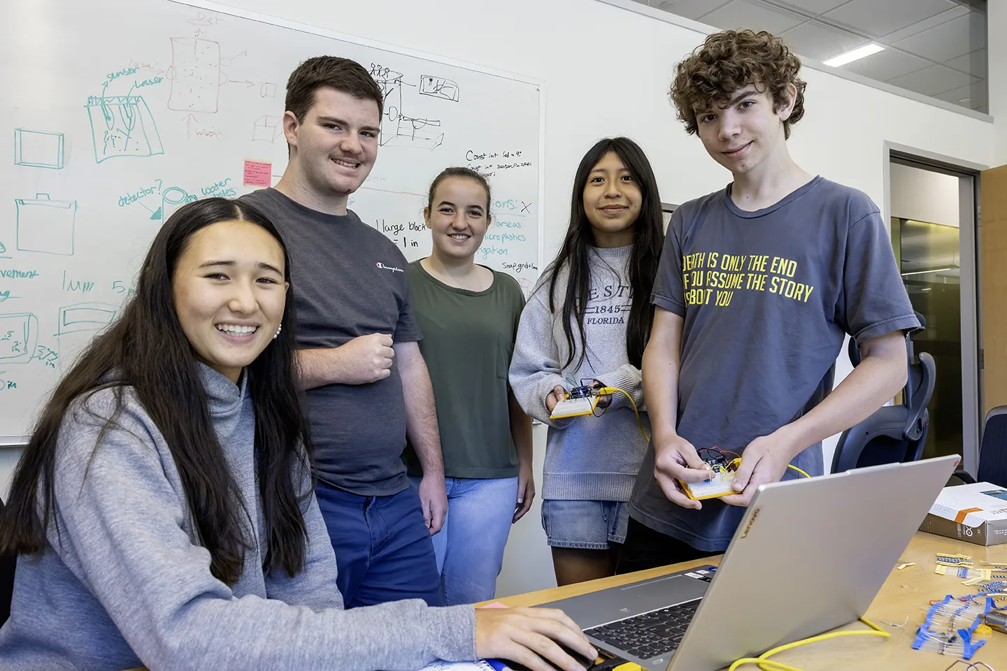 High school students study robotics during a STEM workshop
