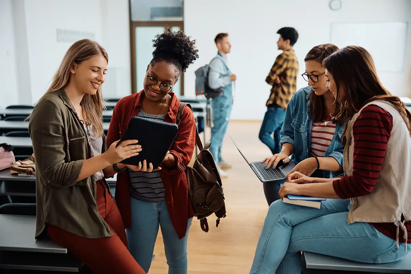 university students looking at an ipad